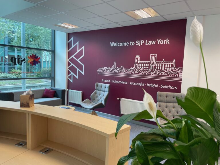The reception at Medical Accident Claimline's York office, with the Welcome to SJP Law York wall